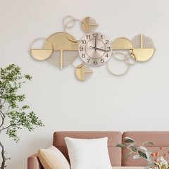 Minimalist wall clock with golden metal frame and glass accents