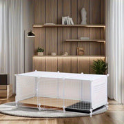Indoor dog crate with built-in toilet area and removable tray