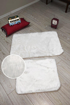 Plush rectangle bath mat set in white with soft fabric finish