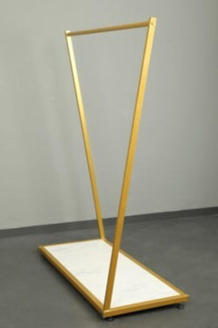 Gold cross-legged standing shelf unit with chipboard shelf