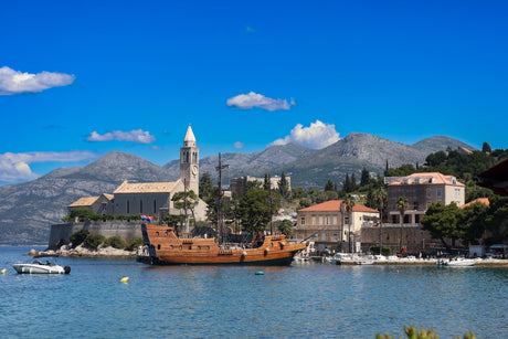 a boat in a body of water with mountains in the background