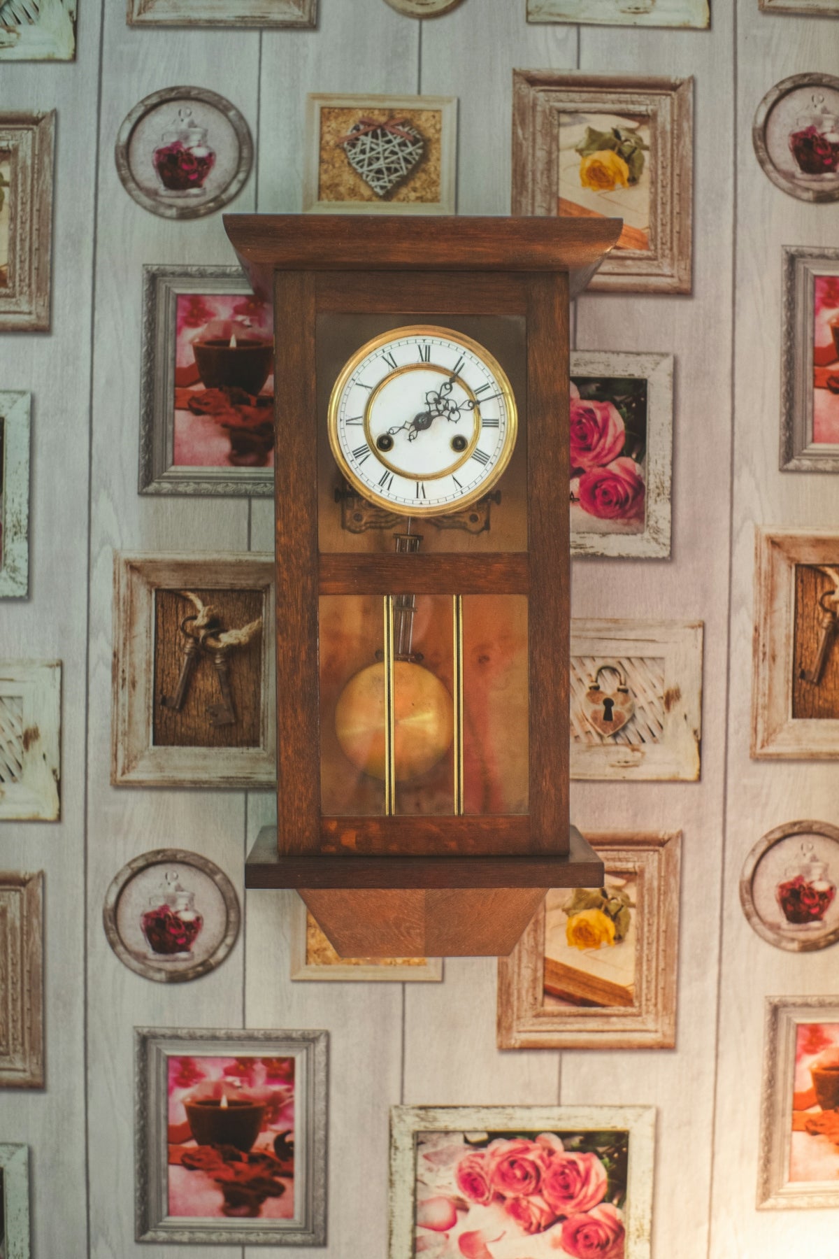 A clock mounted to the side of a wall covered in pictures