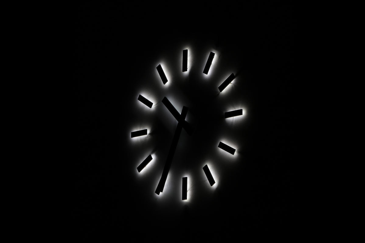 A clock that is lit up in the dark