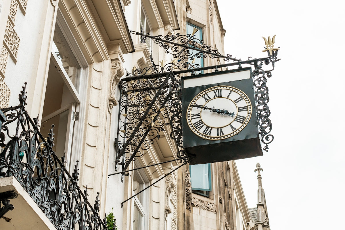 A clock hanging from the side of a building