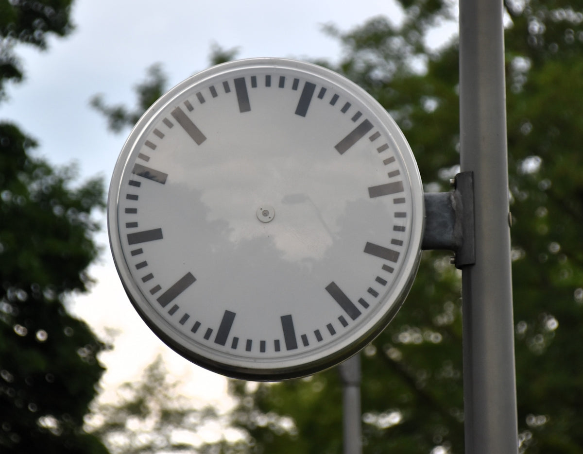 An outdoor clock with no hands.