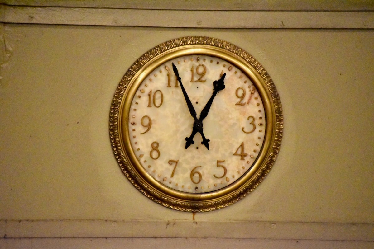 A vintage wall clock shows 11:55