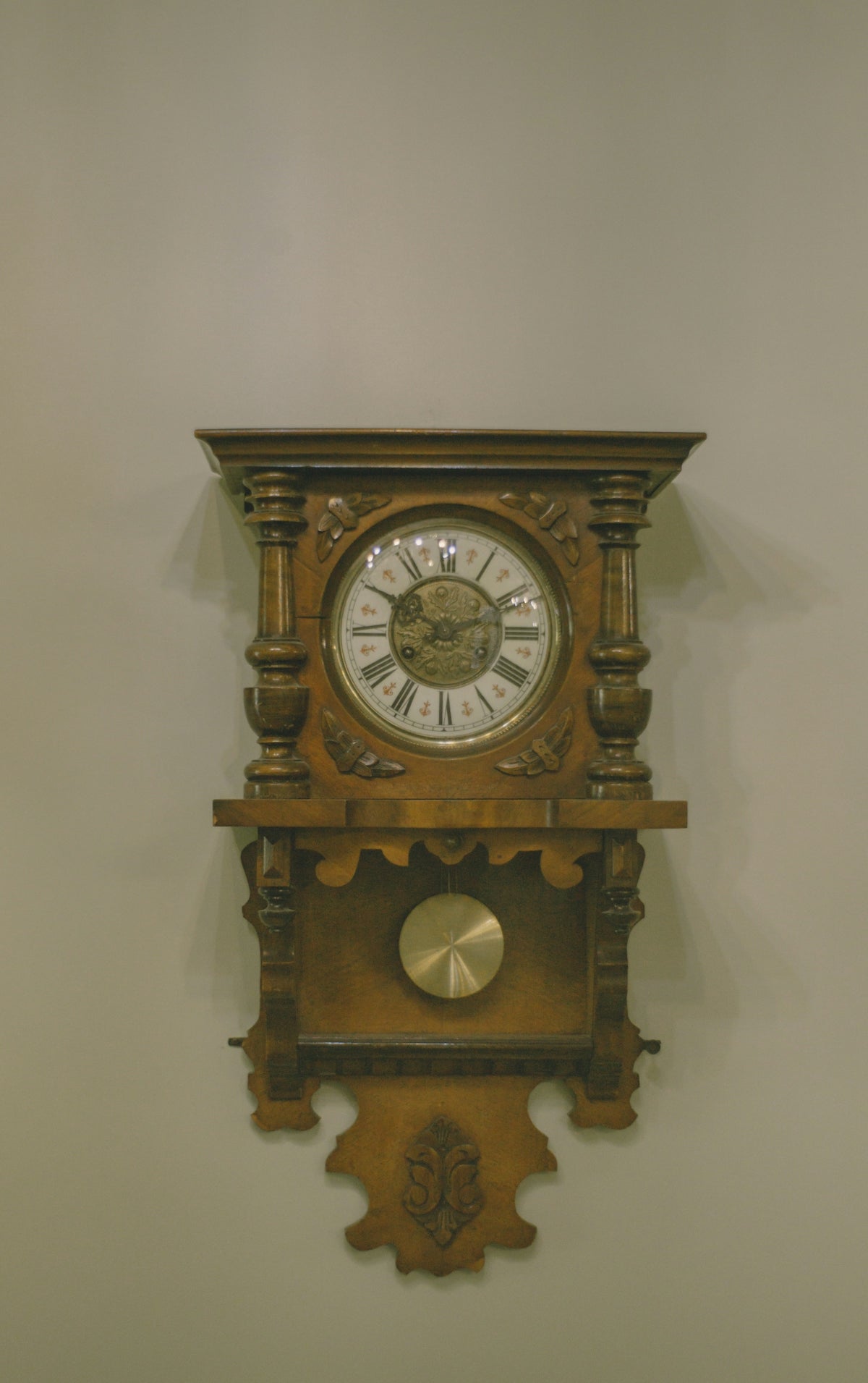 Antique wooden cuckoo clock hanging on wall