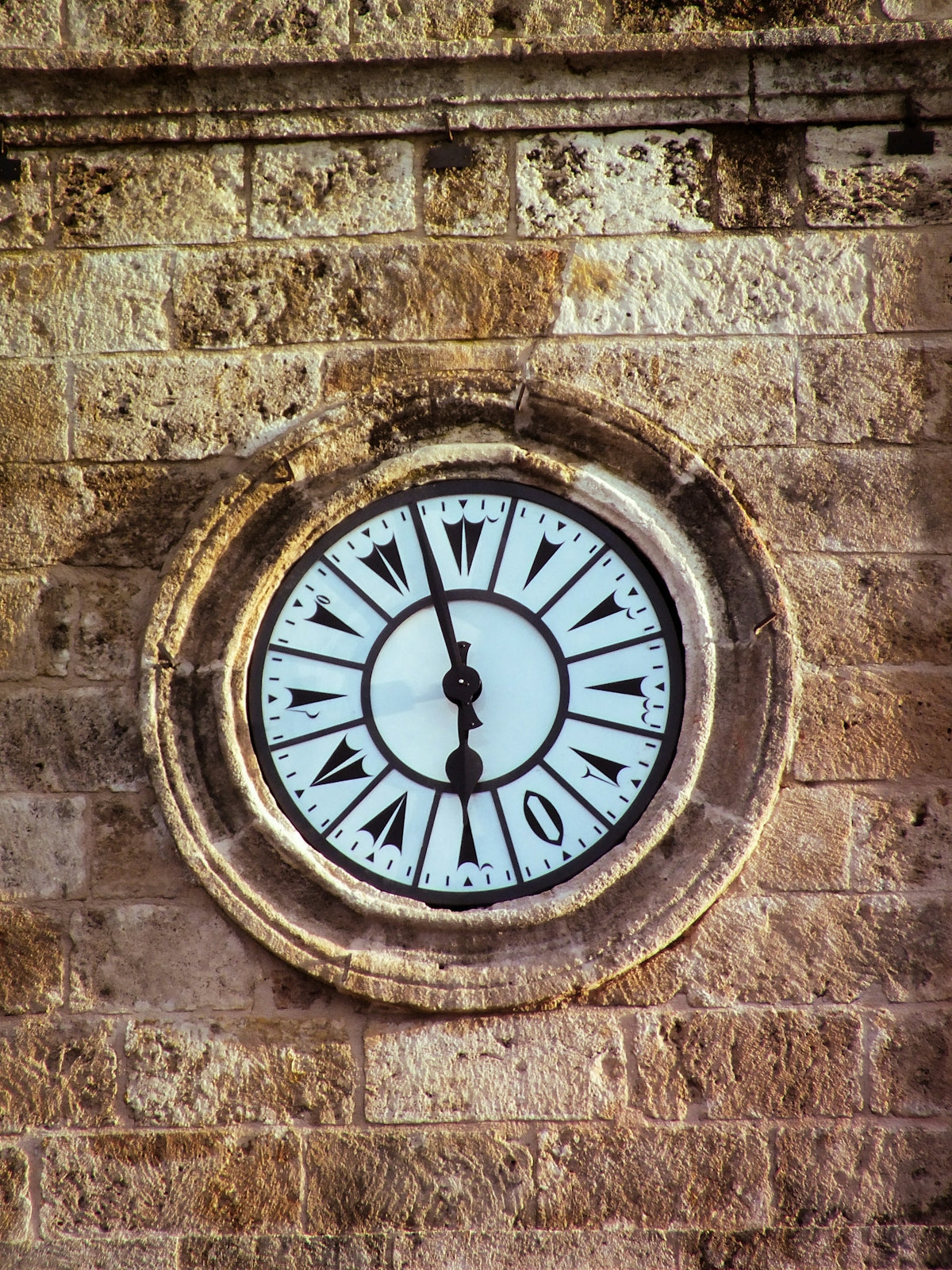 An old clock face on a stone building