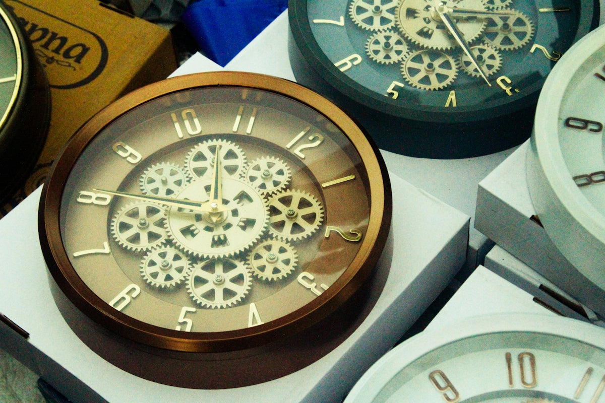 Close-up of decorative wall clocks with visible gears