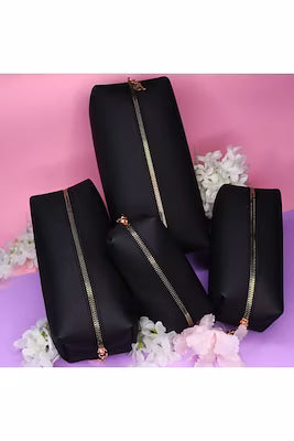 Black set of four small makeup and personal item bags