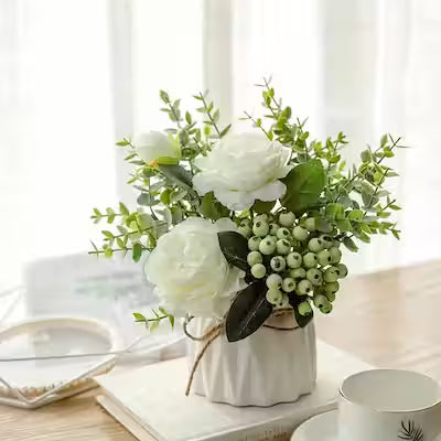 White artificial rose and eucalyptus bouquet in ceramic vase for home decor