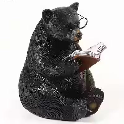 Decorative resin bear statue holding an open book with glasses