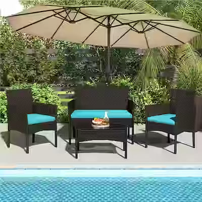 4-piece rattan conversation set with cushioned chairs and glass table