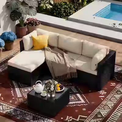 L-shaped outdoor rattan sectional with ottoman and coffee table