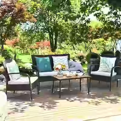 4-piece wicker patio conversation set with cushioned seats and wood table