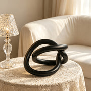 Modern abstract golden knot sculpture with resin finish for home and office decor