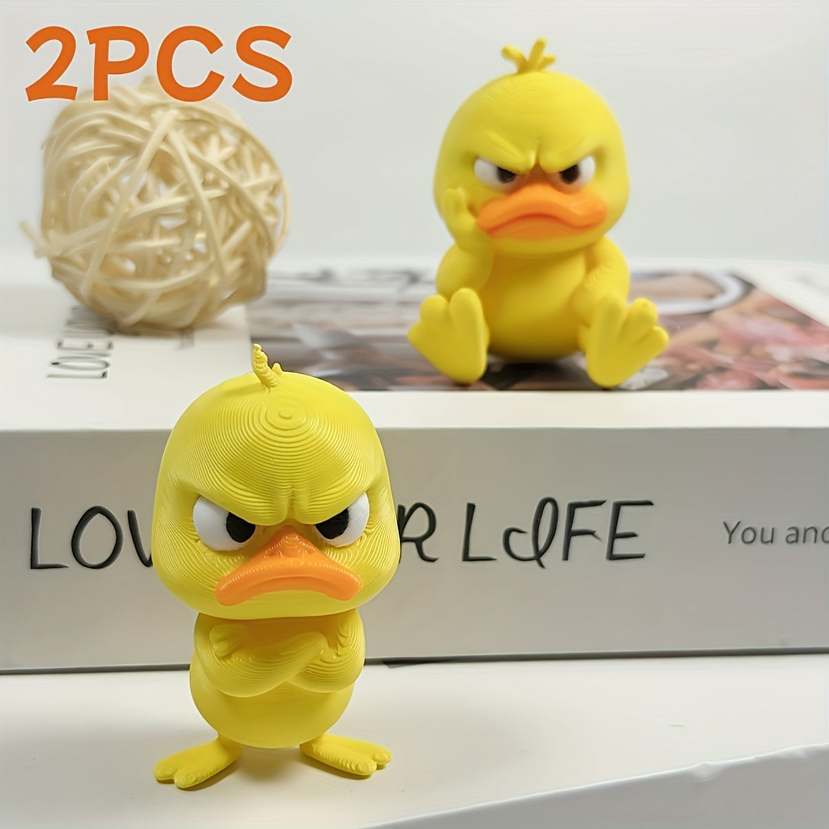 Set of two vibrant yellow angry duck statues for indoor or outdoor decor