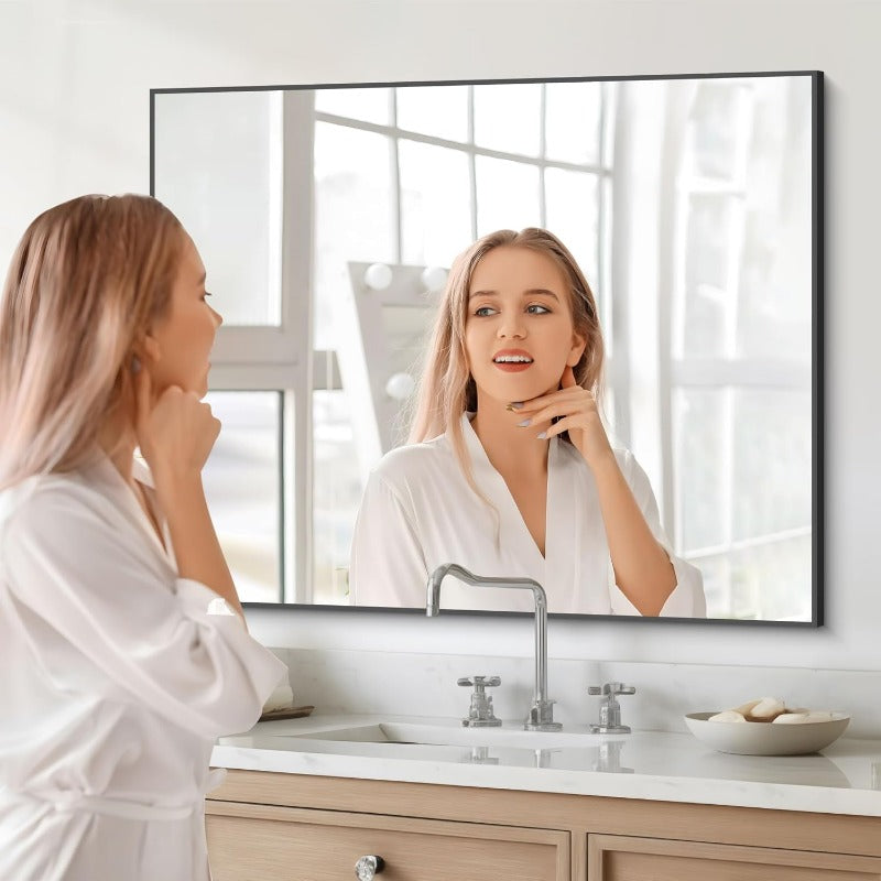 Modern black and gold rectangular wall mirror with thin frame