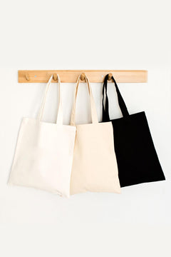 Black, white, and cream colored tote bag with natural fabric