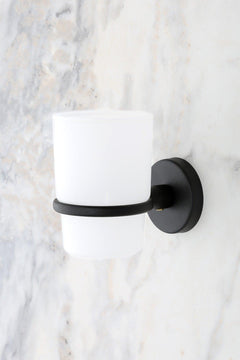 Black wall-mounted toothbrush holder with screws