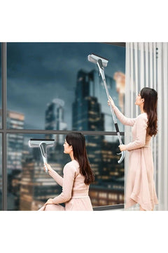 Adjustable windshield wiper with spray nozzle and extension pads